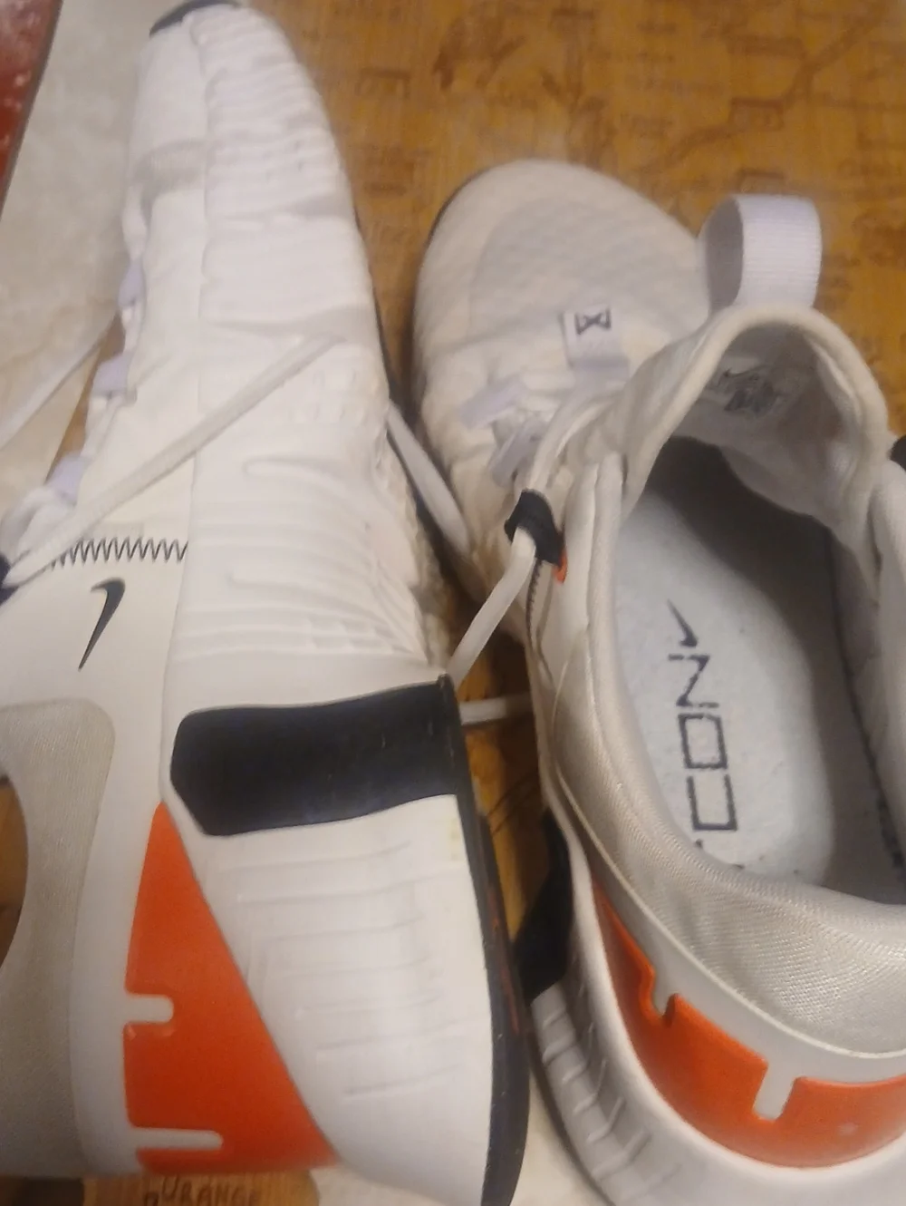 Nike Men’s White Athletic Shoes with Orange and Black Accents